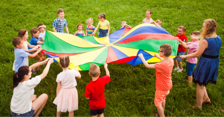 Children playing with a parachute at summer camp